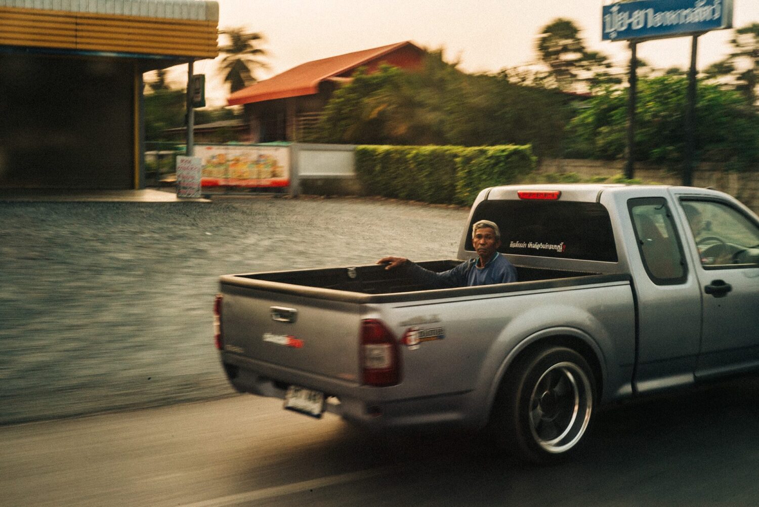 Hitchhiker in the back of a pickup in the highway