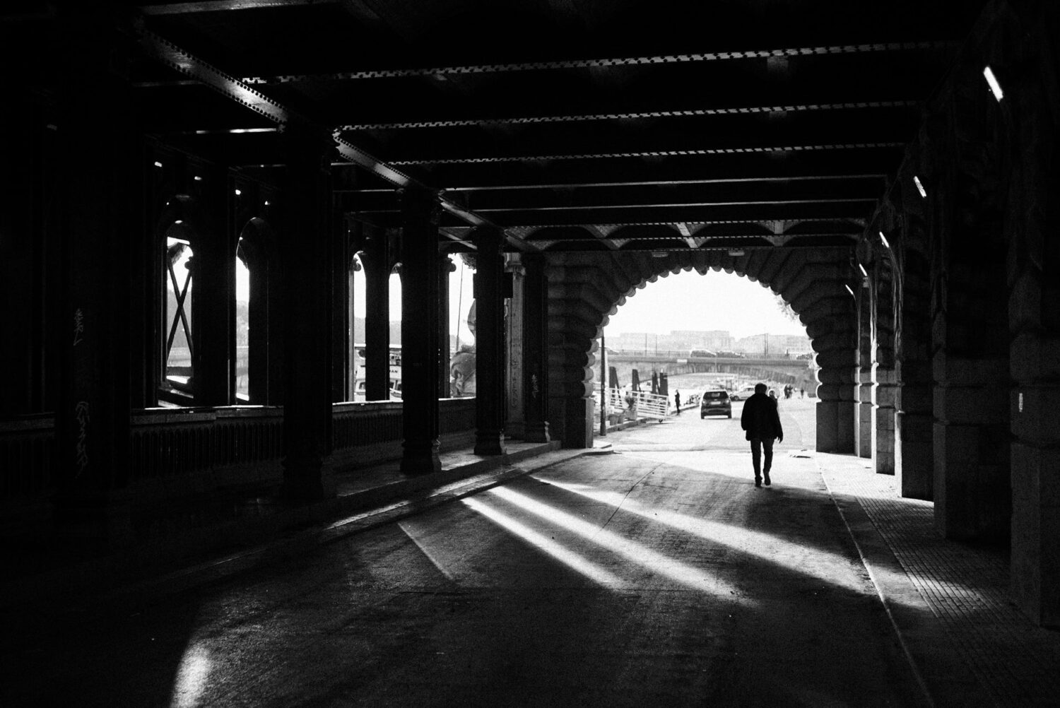 Street-photography-France-12 people passing under metallic bridge in paris, france