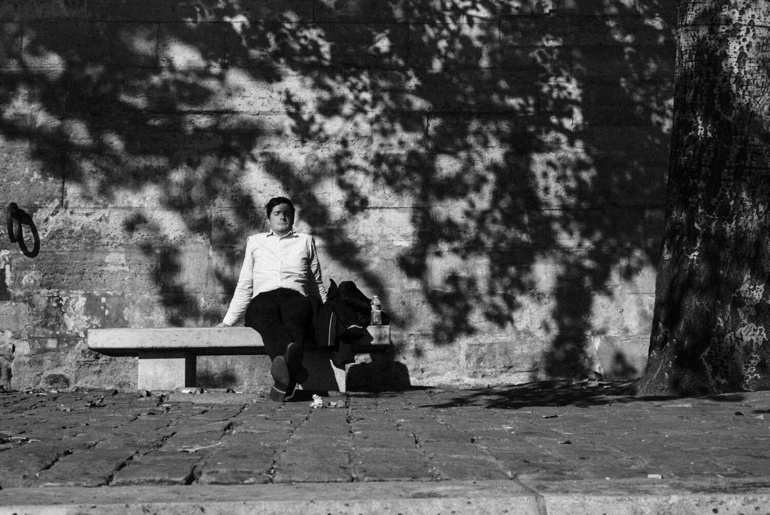 Street-photography-France-19 man taking the sun by the seine river, paris france