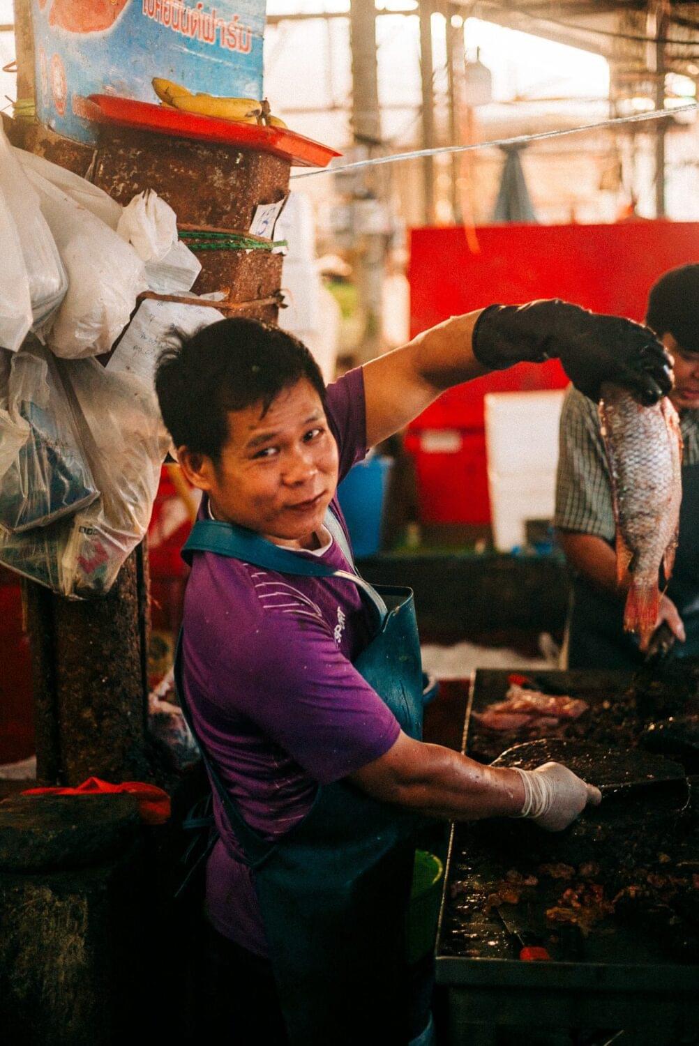 Tourist traveler photographer costa rica 13 Market worker offers a big catch for the picture. I offered a gratitude gesture and we shared a smile. Tourist or traveler? Photo essays: Thailand