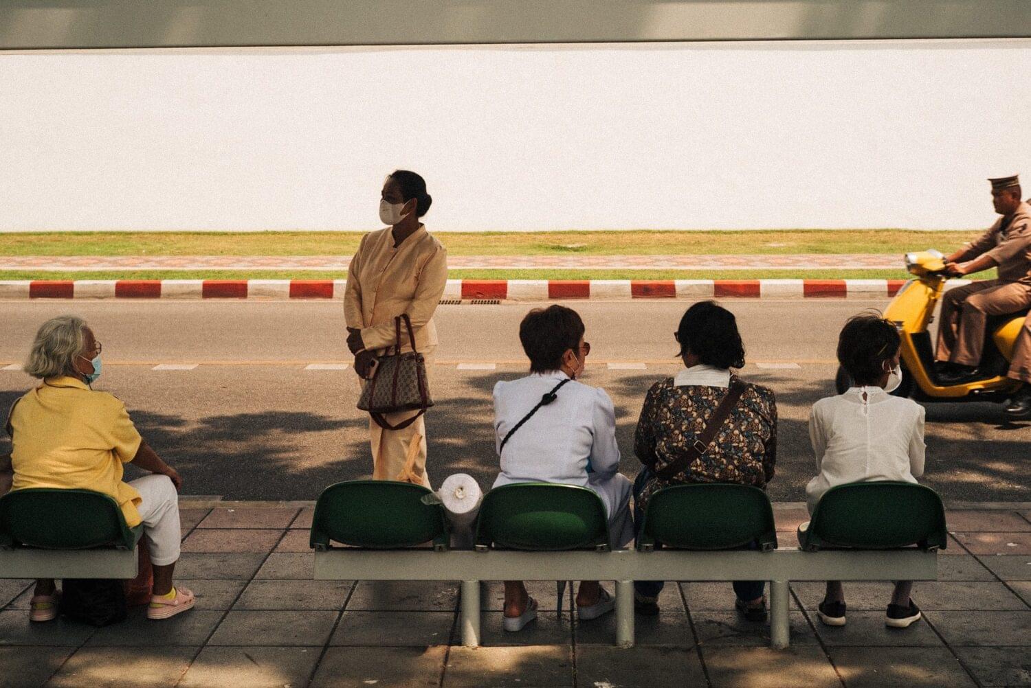 Tourist traveler photographer costa rica 2 A group of people waiting for the bus in front of the Grand Palace in Bangkok, Thailand. Local people usually take public transportation like bus o metro to move in the city, a small percentage take the tuk tuks. Photo essays: Thailand