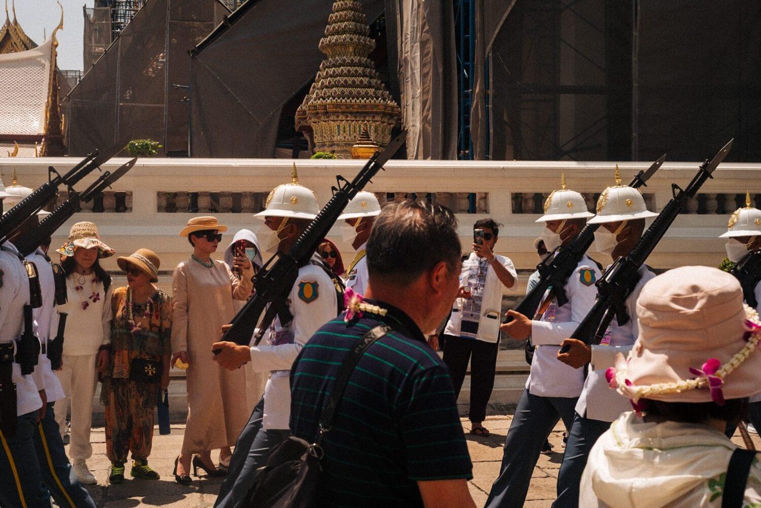 Tourist traveler photographer costa rica 23 Military parade in Bangkok. People take pictures of the aligned soldiers marching in order and dressed identically.