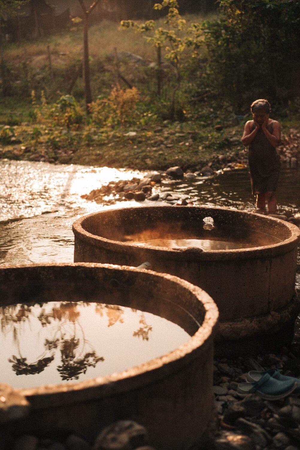 Tourist traveler photographer costa rica 32 Elderly woman taking a Sunday morning bath on natural hot-springs, in a far away town in the north of Thailand.