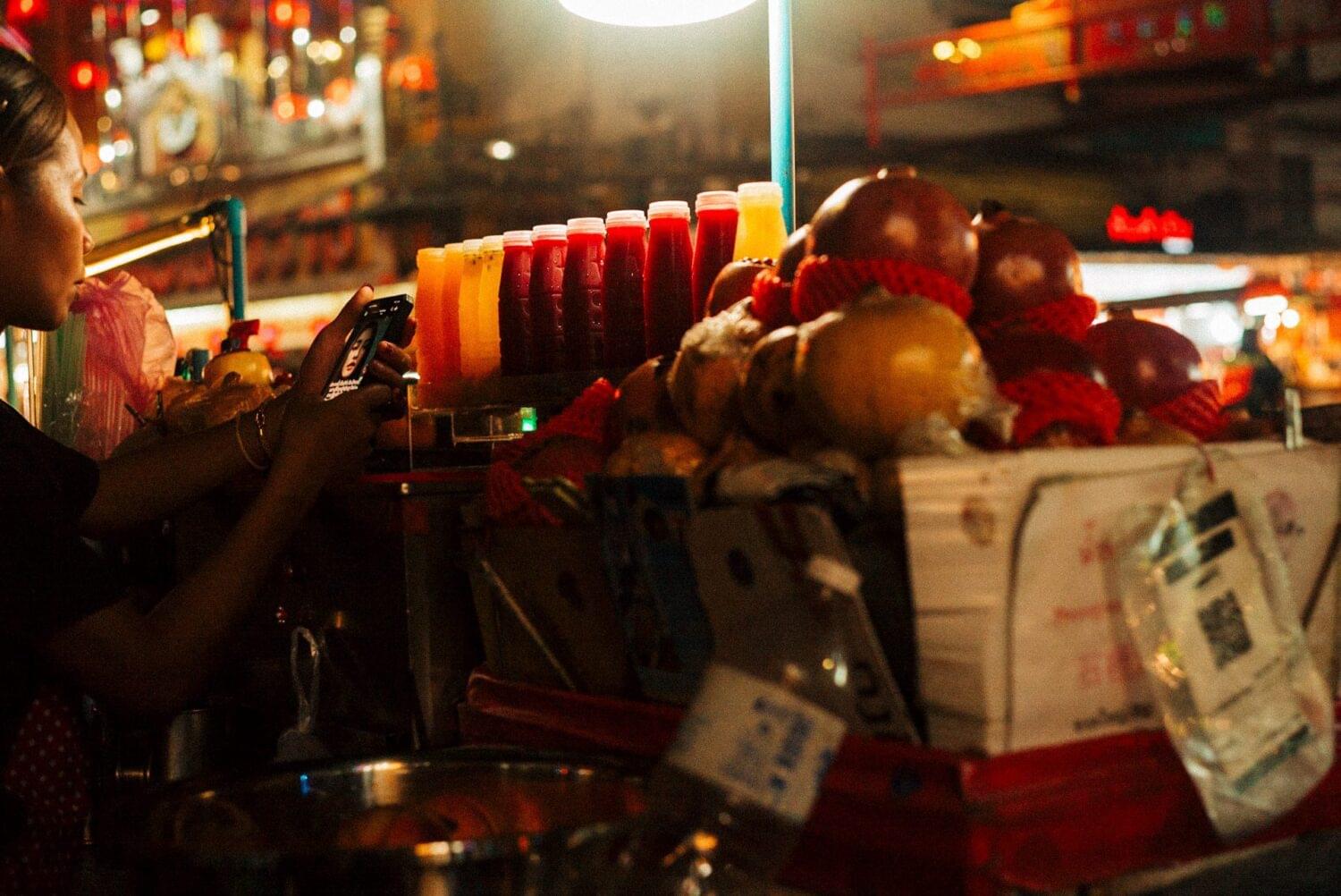 Tourist traveler photographer costa rica 7 Juice seller watching videos at Chinatown, Bangkok. Nightlife in Bangkok seems to exceed the daylight activities and places like Chinatown are the most active when the sun is down. Photo essays: Thailand