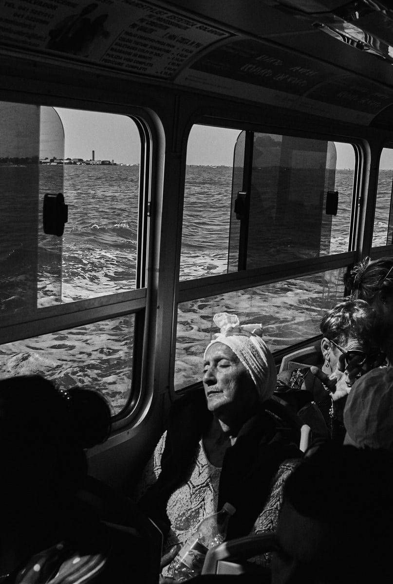 woman on a boat captured by street photography in italy