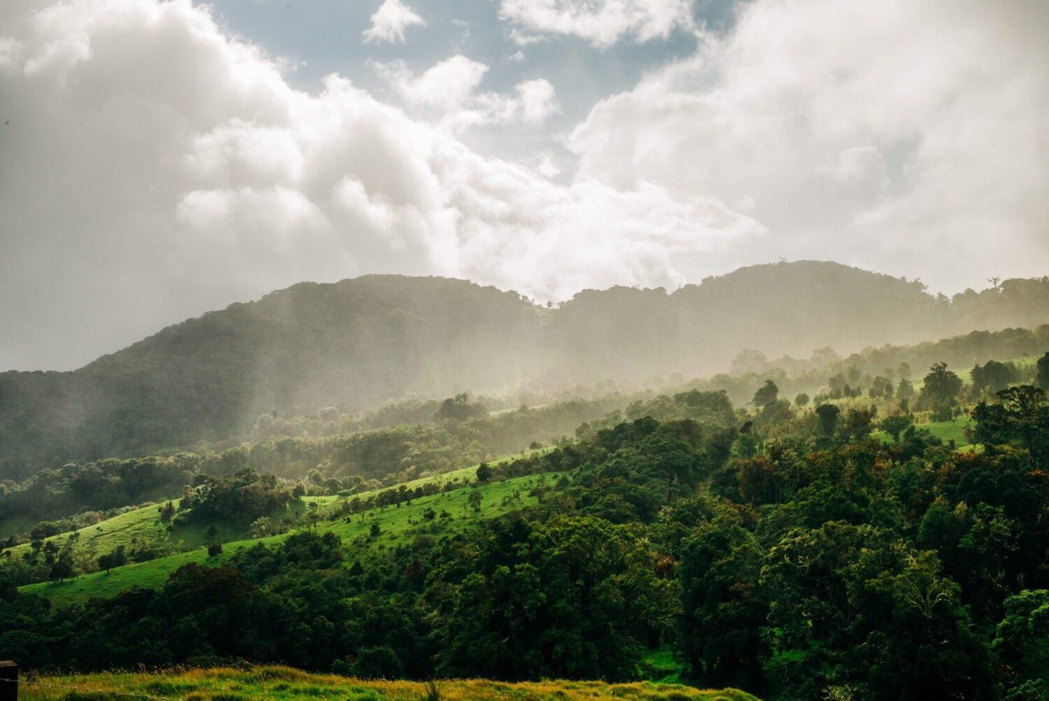 outdoor photography for a light guide of a mountain in costa rica with rain, mist an sun 